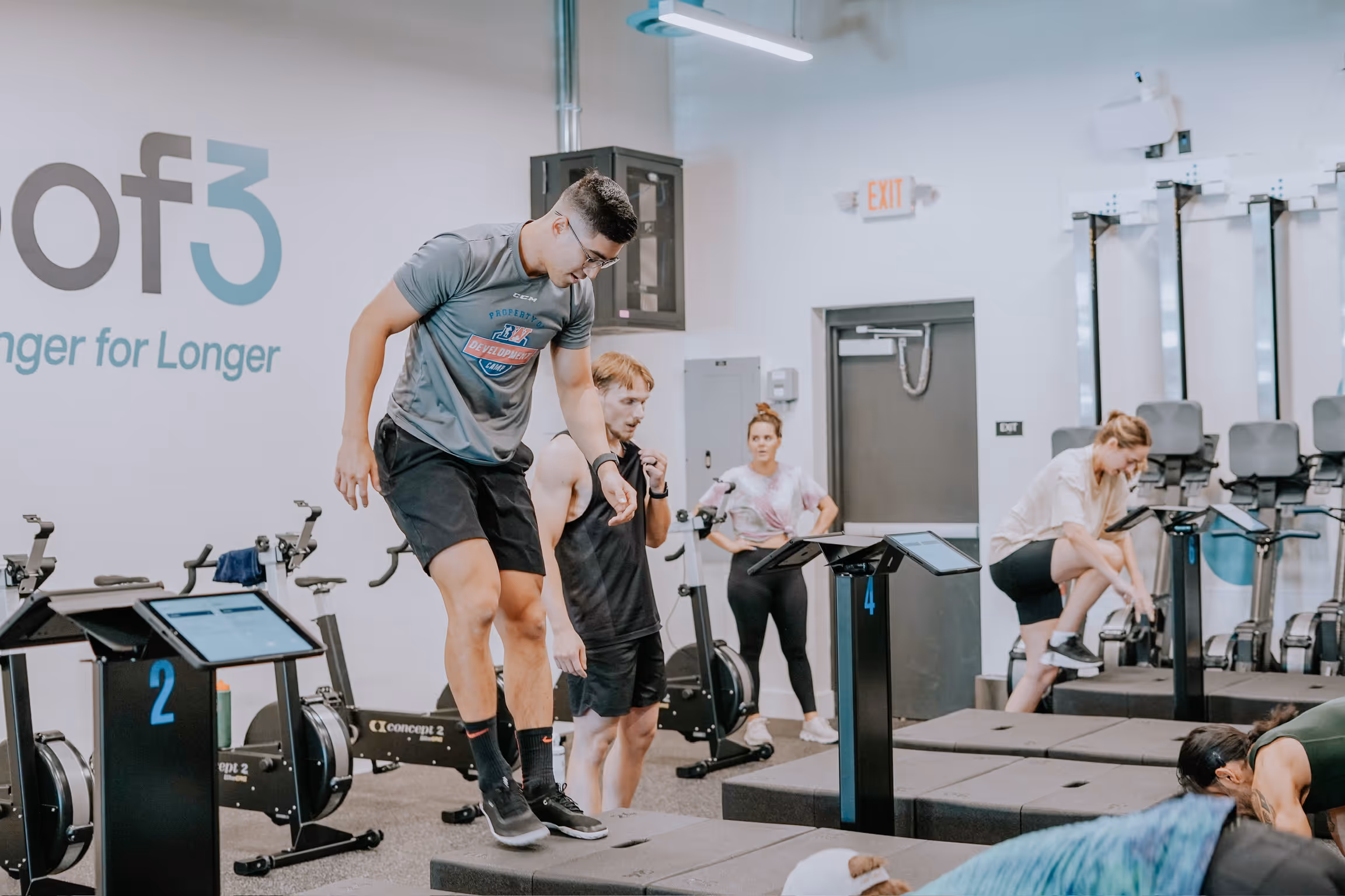 Members training at different workout stations
