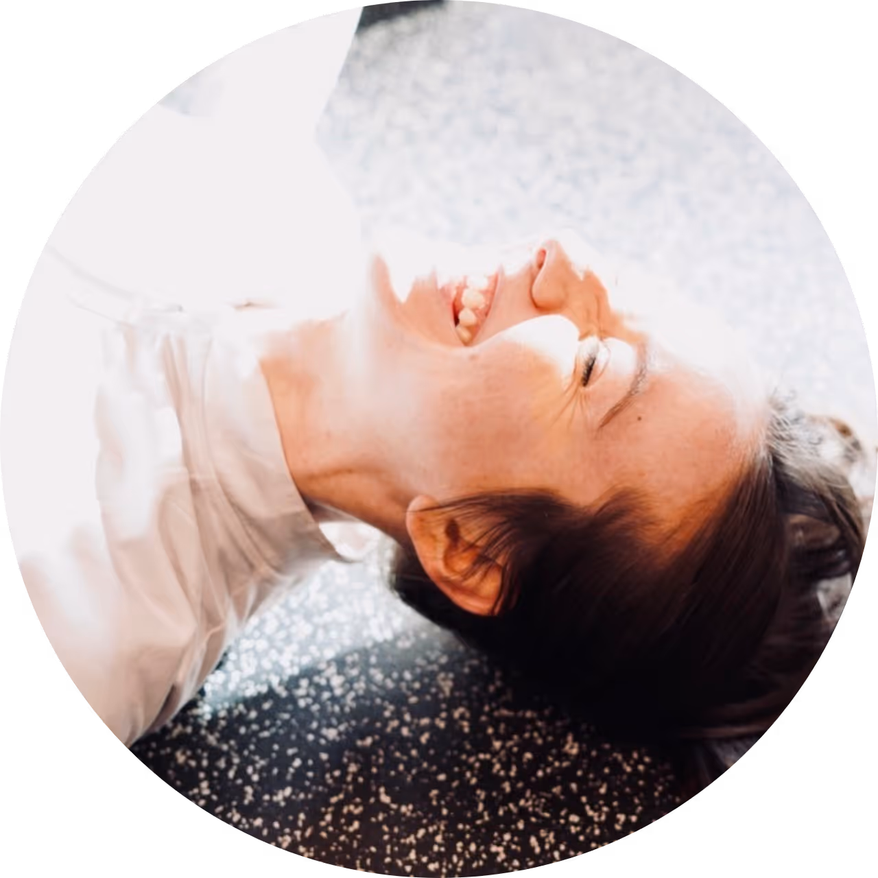 proof3 member, Elena, laying on the ground smiling hugely
